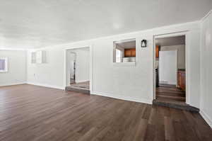 Empty room with dark hardwood / wood-style floors