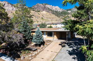 View of front of house with a mountain view and a carport