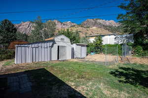 View of yard featuring a storage shed and a mountain view