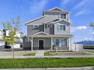 View of front of property featuring a mountain view and a front lawn