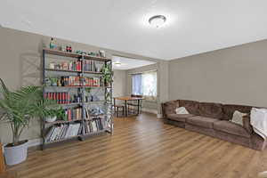 Living room featuring hardwood / wood-style floors and a textured ceiling