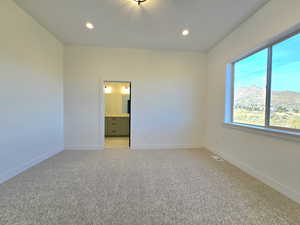 Master on main with carpet flooring and a mountain view