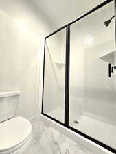 Bathroom featuring toilet and walk in shower