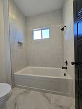 Master Bath. Bathroom with vanity and tiled shower / bath and toilet seperate from sinks