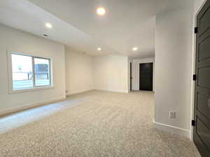 Large Downstairs bedroom with a walk-in closet, under stairs storage, and cold storage entrance.