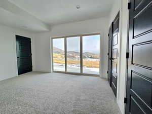 Carpeted spare room featuring a mountain view and jack and jill bathroom