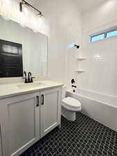 Main Level, Full bathroom featuring toilet, vanity, and tiled shower / bath