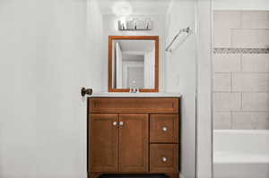 Bathroom featuring vanity and  shower combination