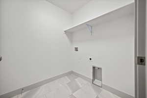 Laundry room featuring tile patterned flooring, hookup for a washing machine, and electric dryer hookup