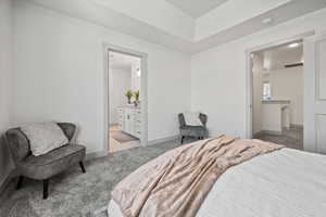 Bedroom with connected bathroom and light carpet