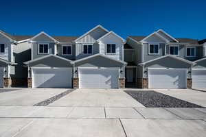 Craftsman-style home featuring board and batten siding, driveway, and a residential view