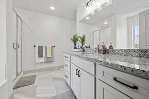 Full bathroom featuring vanity, a shower stall, recessed lighting, and light tile patterned floors