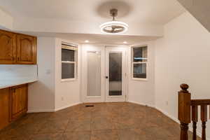 Interior space featuring dark tile patterned floors