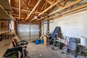 The garage features plenty of storage on the walls and in the space above.