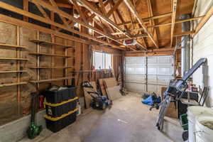 The garage's automatic door opens to the large driveway and has a back door to the yard.