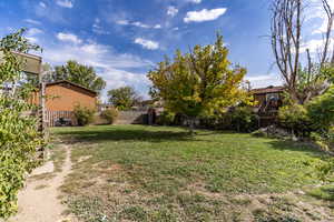 The back yard has direct access to the garage, the basement entrance, the dining area and the front yard through the side gate.