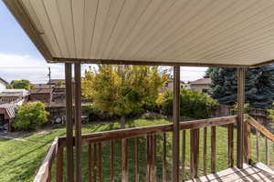 The covered back deck off the dining area offers lovely views of the mature trees.