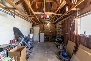 The garage has a workshop area with storage.