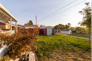 View of yard with a storage shed