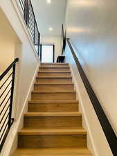 Stairway featuring wood-type flooring