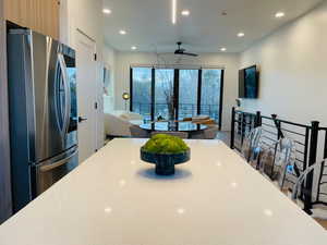 Kitchen with ceiling fan and stainless steel refrigerator