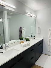 Bathroom featuring vanity, hardwood / wood-style flooring, and walk in shower