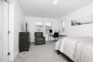 Bedroom featuring light colored carpet