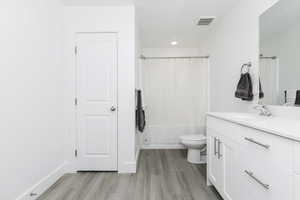 Bathroom featuring vanity, toilet, and hardwood / wood-style flooring