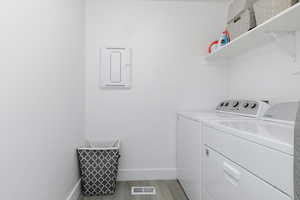 Clothes washing area featuring light hardwood / wood-style floors and separate washer and dryer