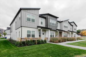 View of front of property with cooling unit and a front lawn