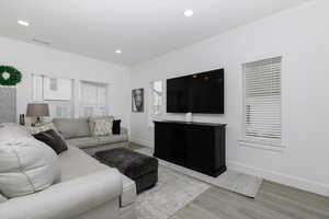 Living room with hardwood / wood-style flooring and a wealth of natural light