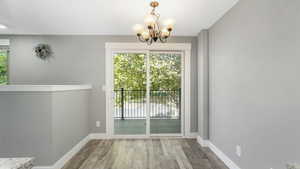 Interior space with an inviting chandelier and wood-type flooring