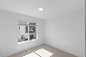 Carpeted bedroom featuring plenty of natural light