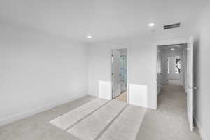 *Photo is of a previously built home of the same layout* bedroom featuring light carpet