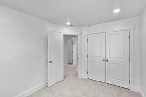 *Photo is of a previously built home of the same layout* bedroom with a closet and light carpet