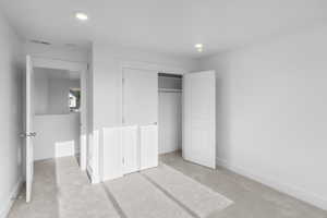 *Photo is of a previously built home of the same layout* Bedroom featuring light colored carpet and a closet