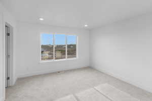 *Photo is of a previously built home of the same layout* Primary Bedroom with light carpet