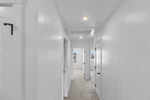 Corridor with light colored carpet