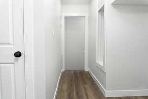 Corridor with dark hardwood / wood-style floors