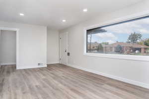 Unfurnished room with light wood-type flooring