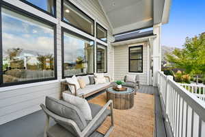 Wooden balcony featuring a wooden deck and an outdoor hangout area