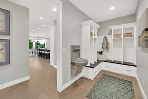 Mudroom with a chandelier and light wood-type flooring