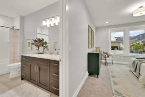 Full bathroom featuring vanity, shower / bath combo with shower curtain, and toilet