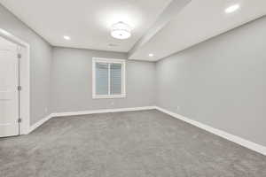 Unfurnished room featuring carpet and a textured ceiling