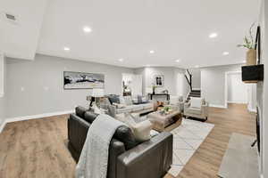 Living room with light hardwood / wood-style floors