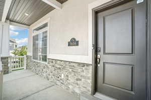 View of exterior entry with covered porch