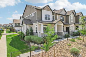 Craftsman inspired home featuring a front lawn, covered porch, and a garage