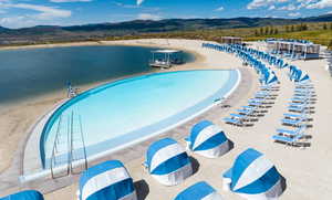 View of pool with a water and mountain view