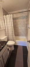 Primary Ensuite Full bathroom with vanity, a textured ceiling, New shower & floor tile. New toilet