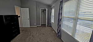 2nd Bedroom featuring a nice size closet, carpet, and vaulted ceiling. Ceiling fan